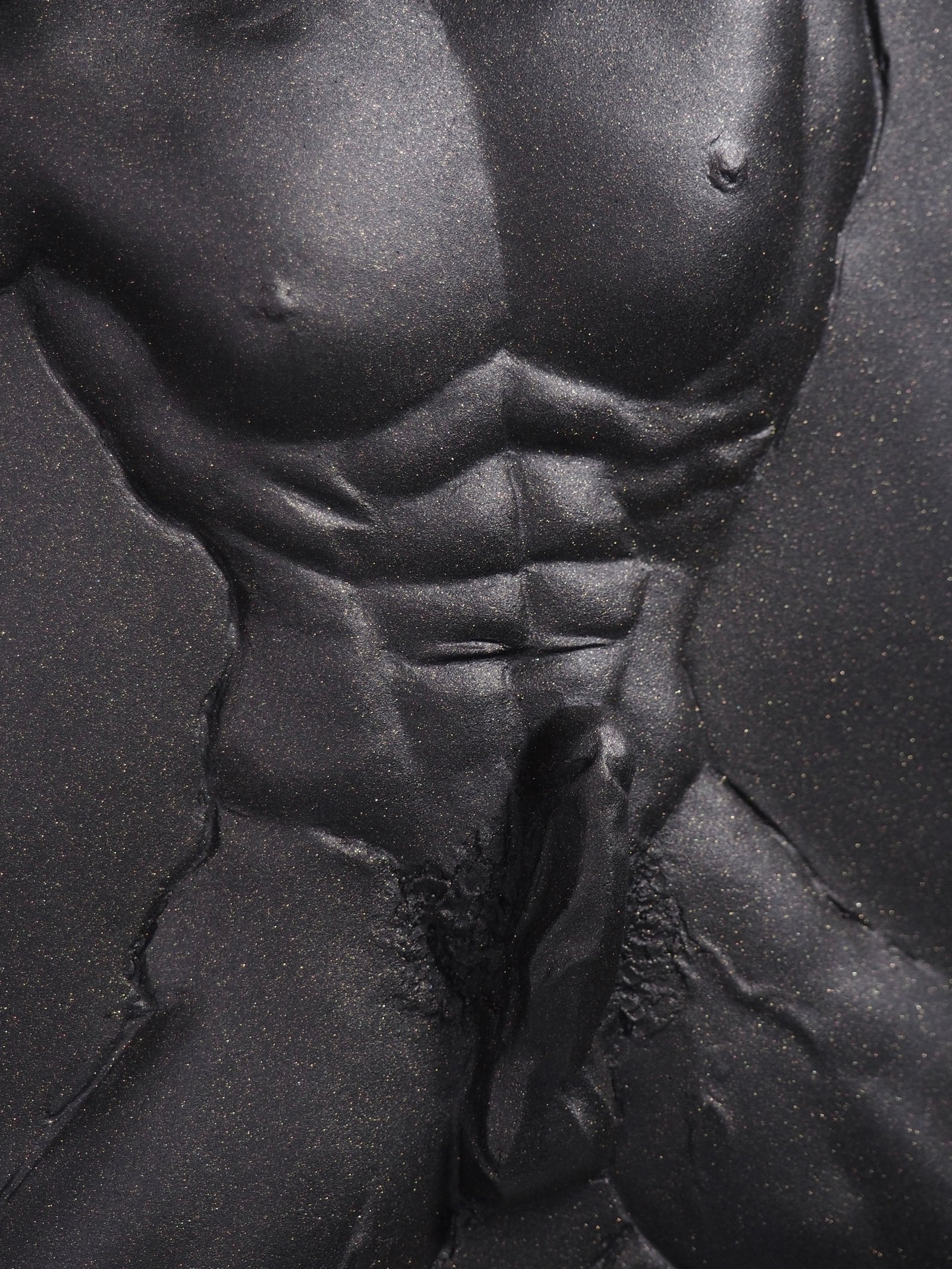 Detail view of Overcome Black Gold resin sculpture