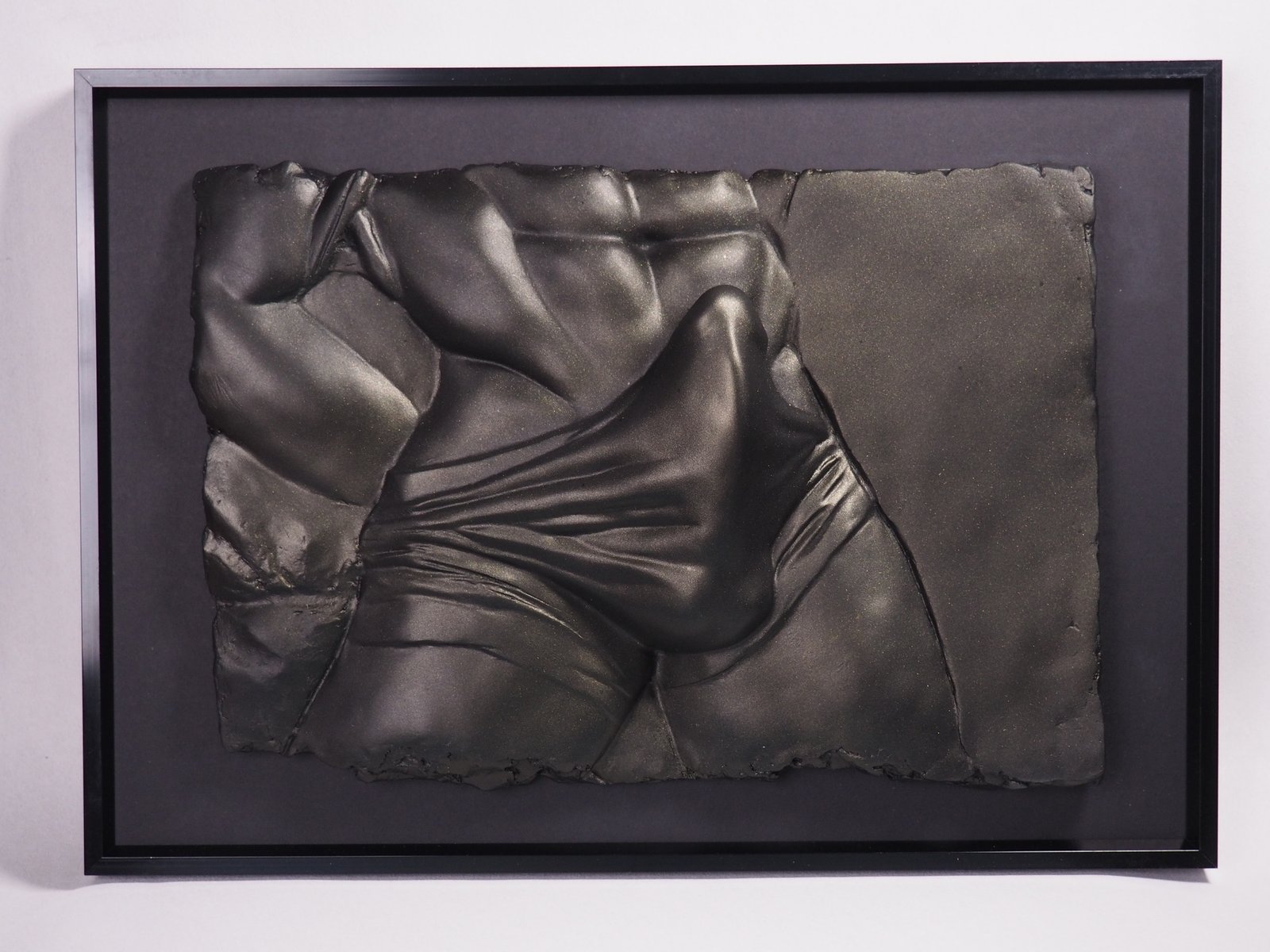 Detail view of The Shape of Want Black Gold resin sculpture