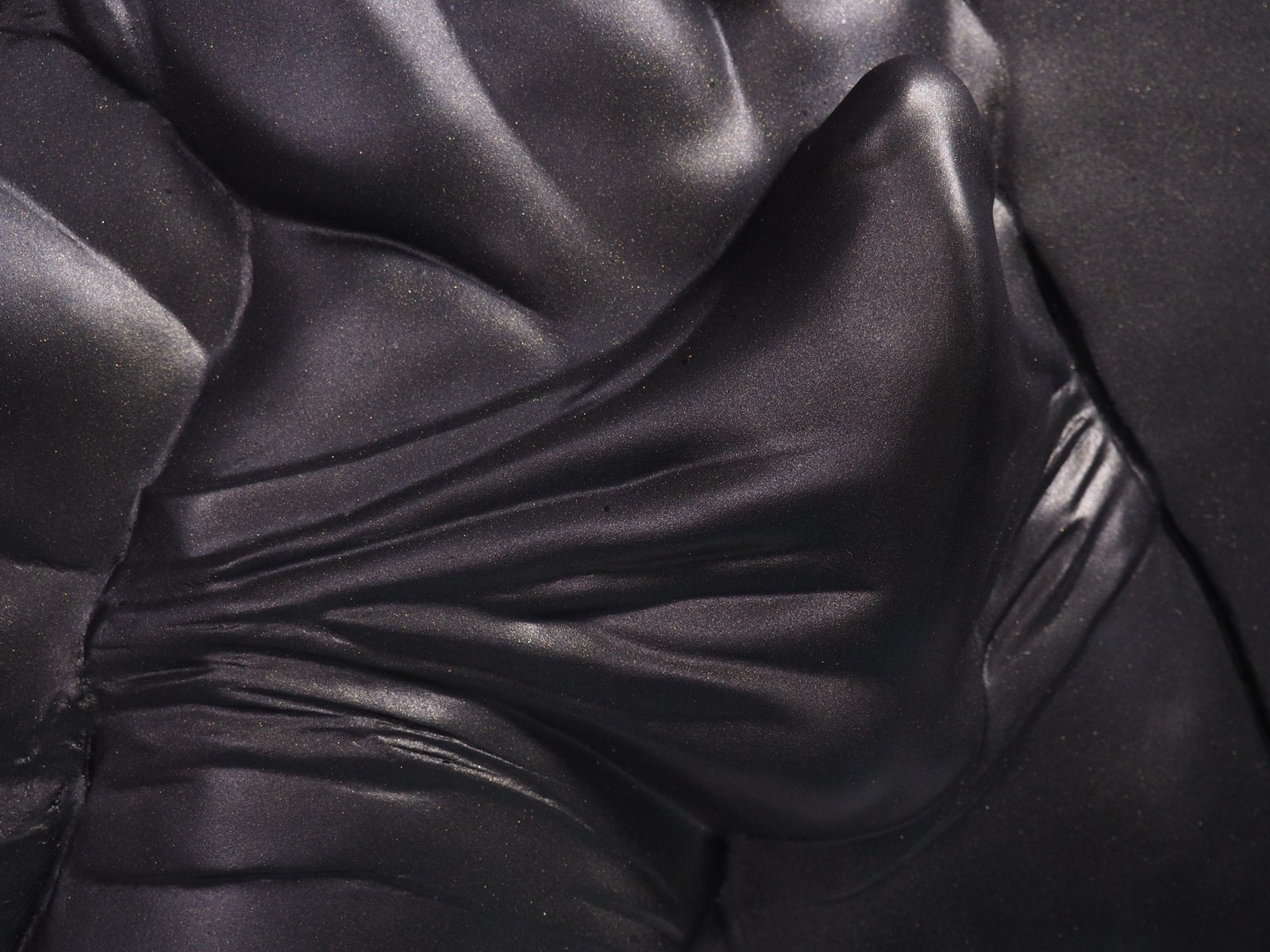 Detail view of The Shape of Want Black Gold resin sculpture